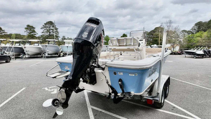 Slide: The Image of 2018 Sea Chaser LX 21 boat on trailer, parked in a lot with other boats. - 5
