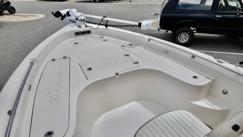 Slide: The Image of 2018 Sea Chaser LX 21 boat deck with storage compartments and trolling motor. - 6