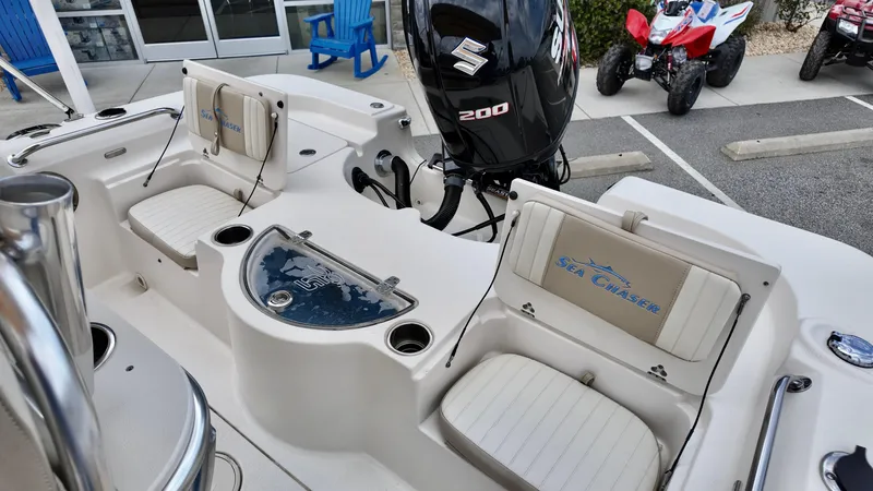 Slide: The Image of 2018 Sea Chaser LX 21 boat interior with Suzuki 200 engine, featuring seating and storage. - 9