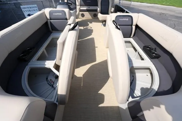 Slide: The Image of 2025 Harris Cruiser 230 interior with beige seating and storage compartments. - 10