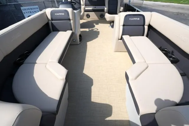 Slide: The Image of 2025 Harris Cruiser 230 interior with beige seating and cup holders. - 11