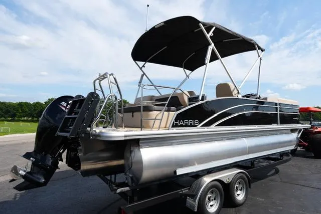 Slide: The Image of 2025 Harris Cruiser 230 pontoon boat on trailer, featuring sleek design and canopy. - 6