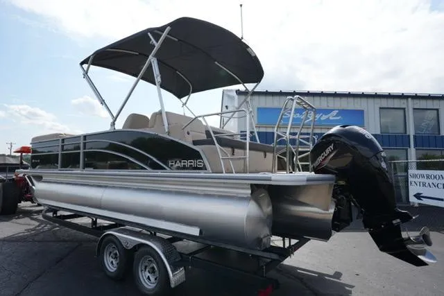 Slide: The Image of 2025 Harris Cruiser 230 pontoon boat on trailer, featuring a Mercury outboard motor. - 8