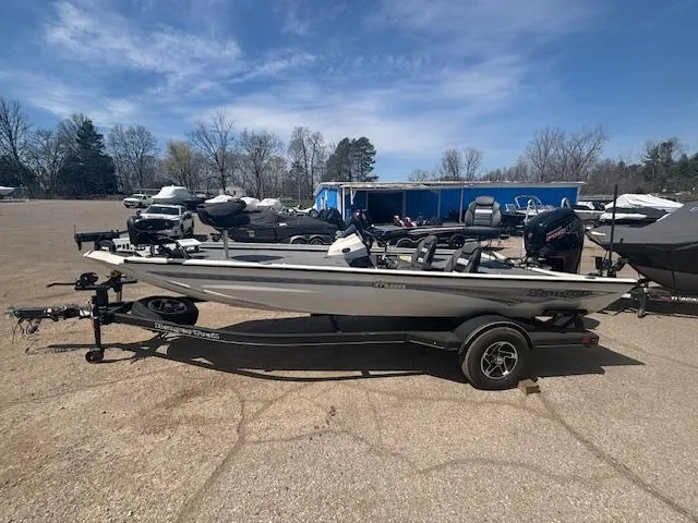 Slide: The Image of 2024 Ranger RT188 boat on trailer in outdoor lot under blue sky. - 5
