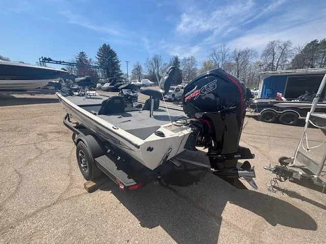 Slide: The Image of 2024 Ranger RT188 boat with motor on trailer in outdoor setting. - 6