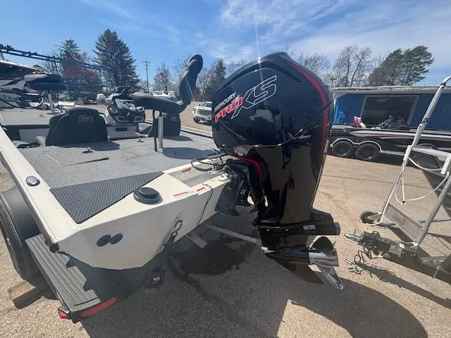 Slide: The Image of 2024 Ranger RT188 boat with powerful outboard motor, parked outdoors on a sunny day. - 7