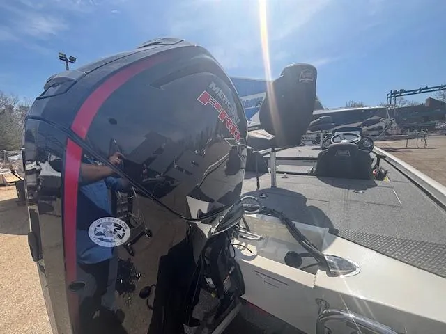 Slide: The Image of 2024 Ranger RT188 boat with powerful Mercury outboard motor, parked outdoors under clear blue sky. - 8