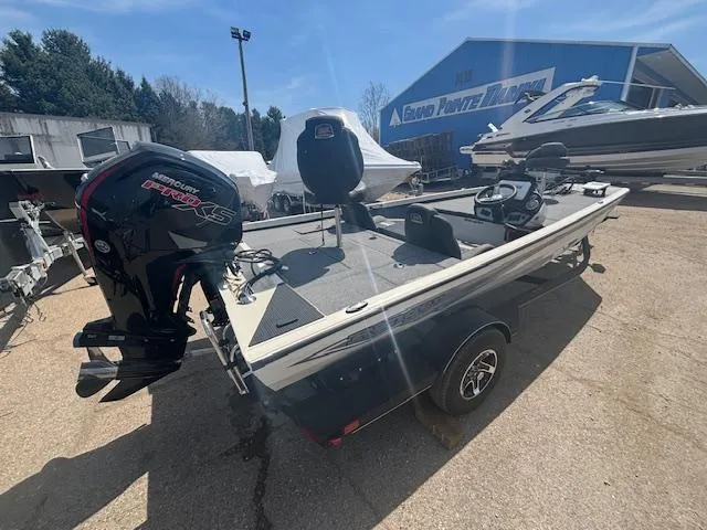 Slide: The Image of 2024 Ranger RT188 boat with Mercury engine, parked outdoors near other boats. - 9