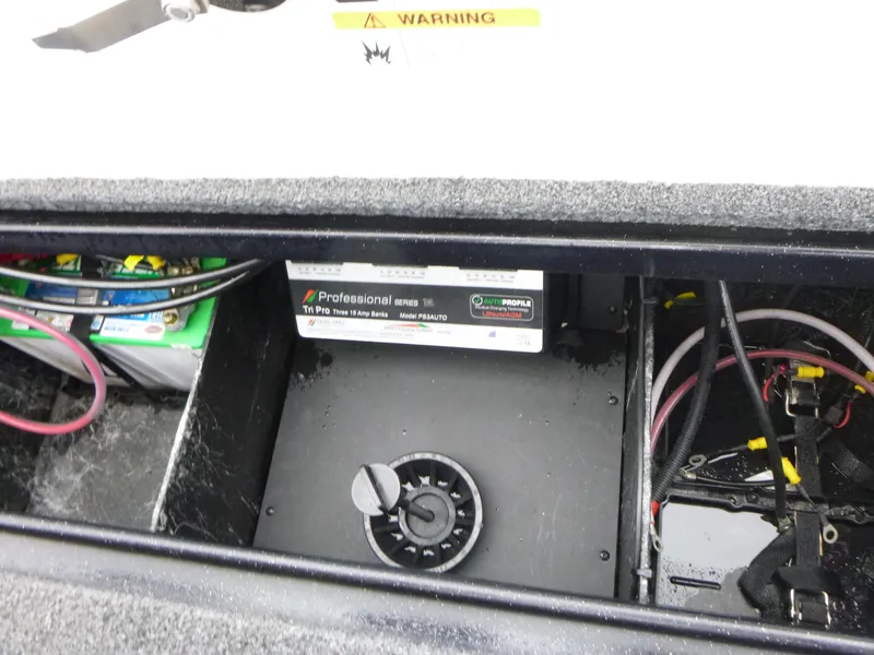 Slide: The Image of 2023 Ranger Z518 boat battery compartment with wiring and warning label. - 10