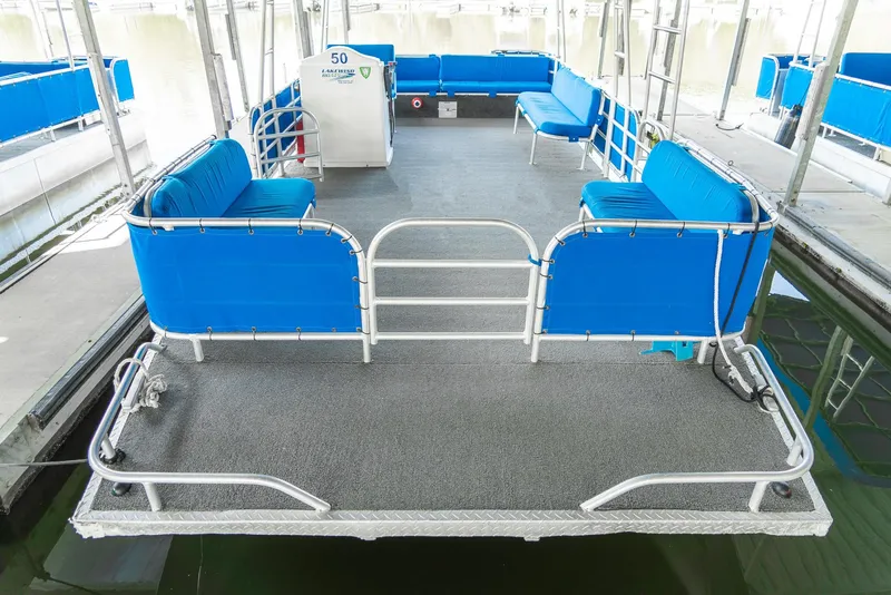 Slide: The Image of Pontoon boat with blue seating, Custom Lake Wind 25 x 10, year 2000, docked. - 11