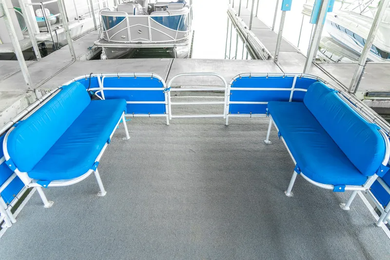 Slide: The Image of Custom Lake Wind 25 x 10 Pontoon, 2000 model, with blue seating and spacious deck. - 14