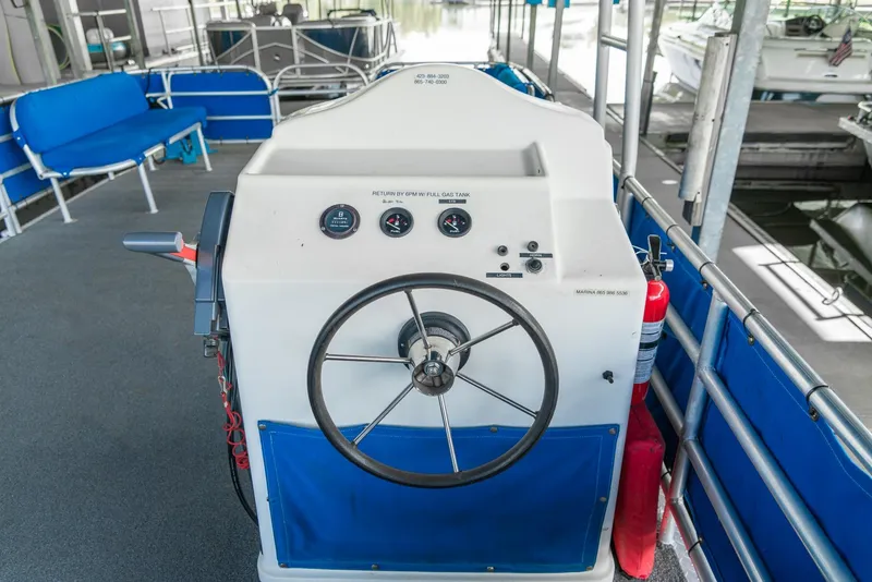 Slide: The Image of 2000 Custom Lake Wind 25 x 10 Pontoon boat helm with steering wheel and gauges. - 21