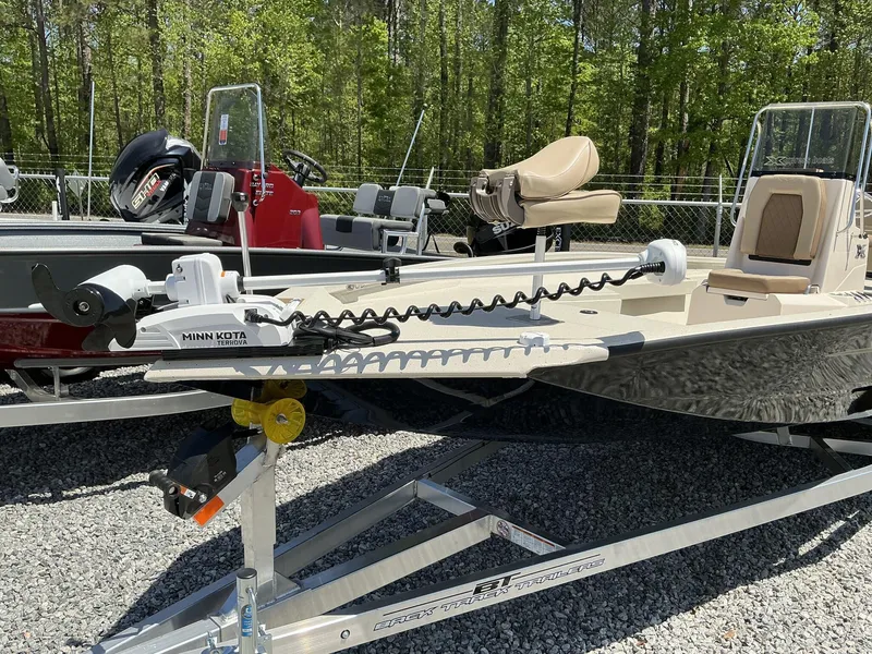 Slide: The Image of 2025 Xpress Hyper-Lift H22B boat with Minn Kota Terrova motor, on trailer, in outdoor setting. - 2