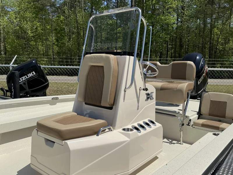 Slide: The Image of 2025 Xpress Hyper-Lift Series H22B boat with Terrova, stereo, and Suzuki engine in a wooded setting. - 4