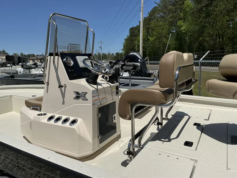 Slide: The Image of 2025 Xpress Hyper-Lift Series H22B boat interior with steering console and seating. - 8