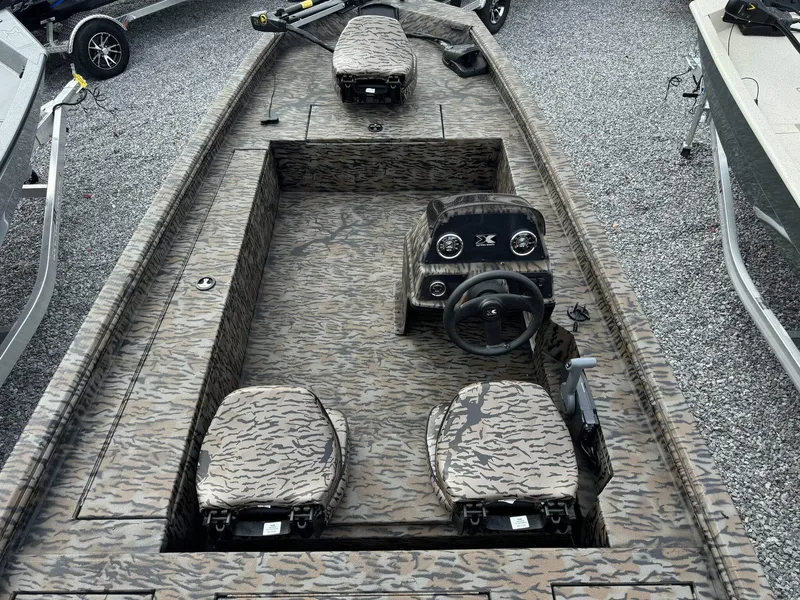 Slide: The Image of 2025 Xpress Xplorer Series XP180 boat with camouflage interior, steering console, and seating. - 4