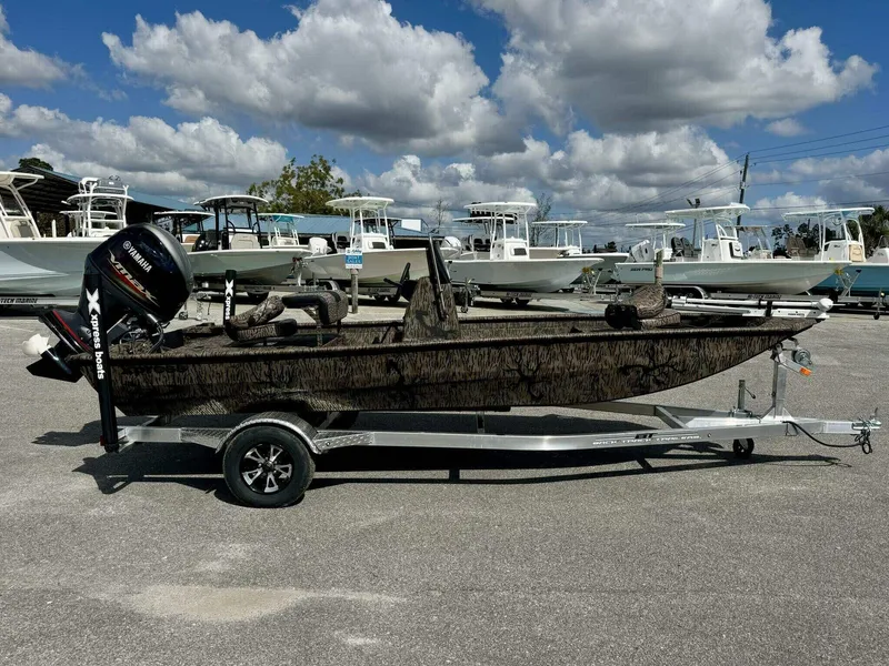 Slide: The Image of 2025 Xpress Xplorer Series XP18CC boat on trailer under cloudy sky. - 1