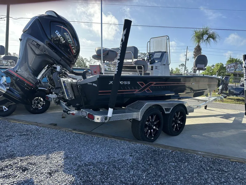 Slide: The Image of 2025 Xpress Hyper-Lift Series H22B boat on trailer, featuring powerful outboard motor. - 10