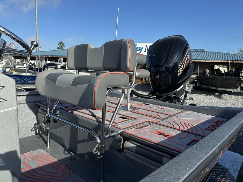 Slide: The Image of 2025 Xpress Hyper-Lift Series H22B boat with seating and motor, under clear blue sky. - 4