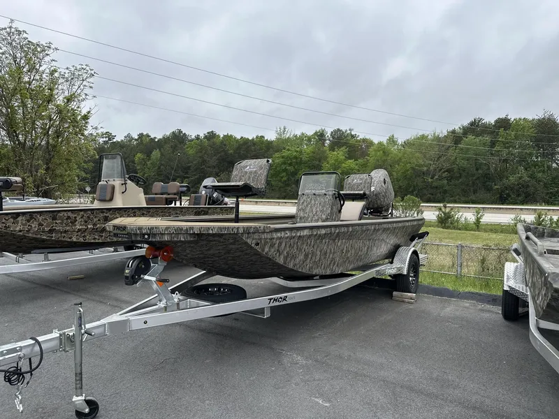 Slide: The Image of 2025 Thor LAKE HAMMER 1900 CC boat on trailer, parked outdoors. - 1