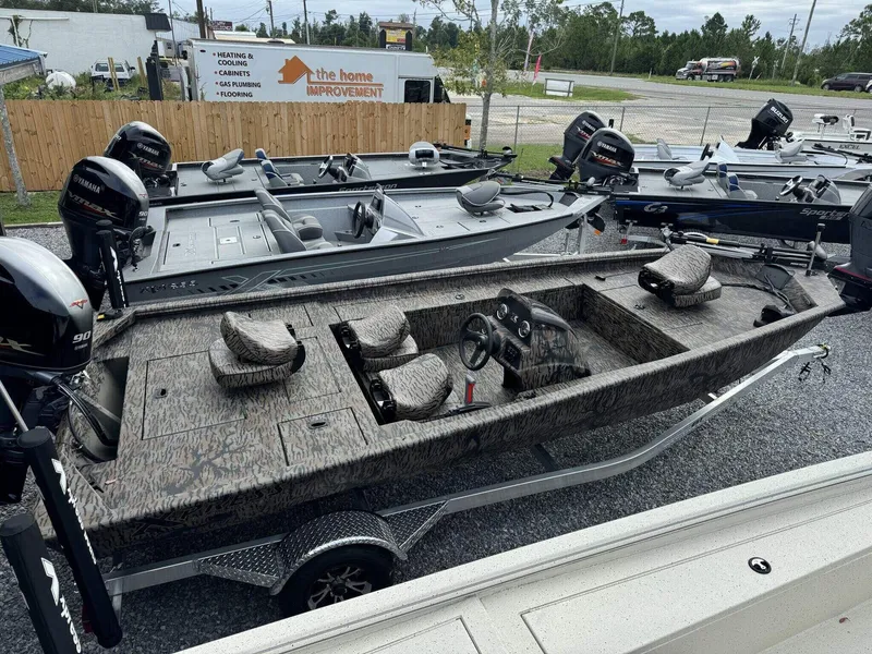 Slide: The Image of 2025 Xpress Xplorer Series XP180 boat with camo design, displayed outdoors. - 3