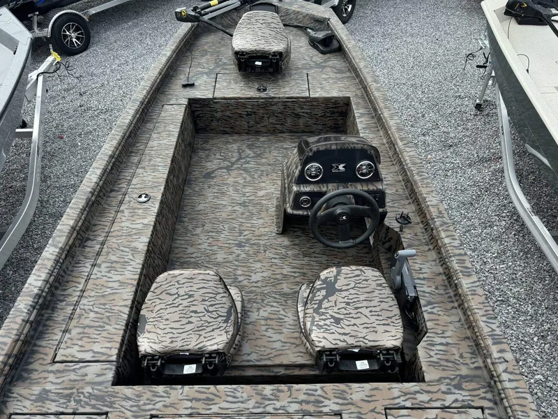 Slide: The Image of 2025 Xpress Xplorer Series XP180 boat with camouflage interior on gravel. - 4