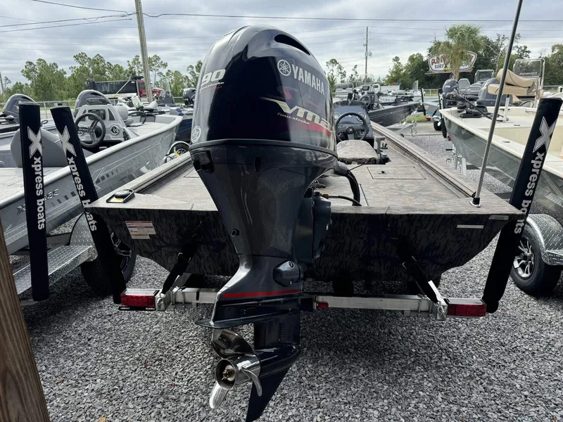 Slide: The Image of 2025 Xpress Xplorer Series XP180 boat with Yamaha motor, parked on gravel lot. - 6