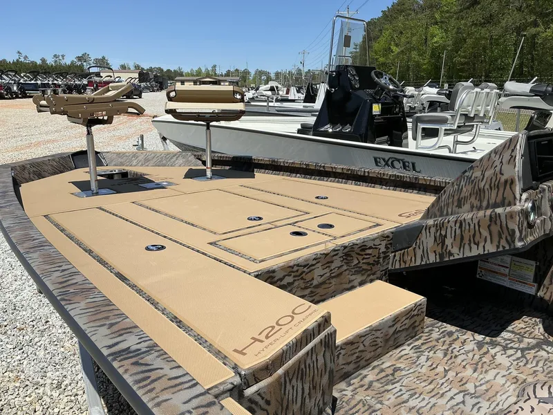 Slide: The Image of 2025 Xpress Hyper-Lift Crappie Series H20 boat with camo design and fishing seats. - 5
