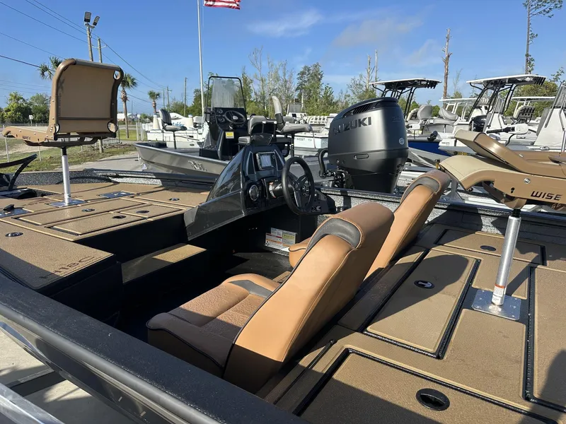 Slide: The Image of 2025 Xpress Hyper-Lift Series H18 Crappie Model boat with tan seating and Suzuki engine. - 4