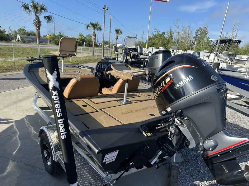 Slide: The Image of 2025 Xpress Hyper-Lift Series H18 Crappie Model boat with Yamaha engine, parked outdoors. - 6