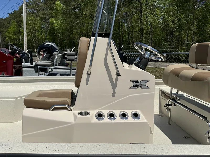 Slide: The Image of 2025 Xpress Hyper-Lift Series H22B boat interior with steering console and seating. - 5