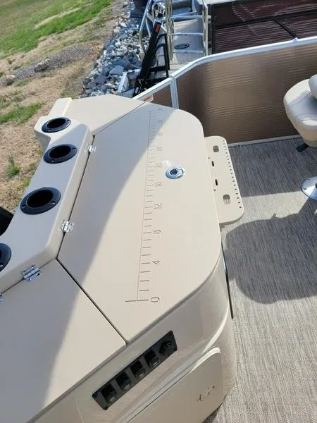 Slide: The Image of 2023 Godfrey Sweetwater SW2286F boat deck with beige seating and measuring panel. - 10