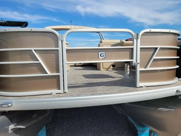 Slide: The Image of 2023 Godfrey Sweetwater SW2286F pontoon boat with beige exterior and open deck. - 2