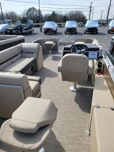 Slide: The Image of 2023 Godfrey Sweetwater SW2286F pontoon boat interior with beige seating and modern dashboard. - 3