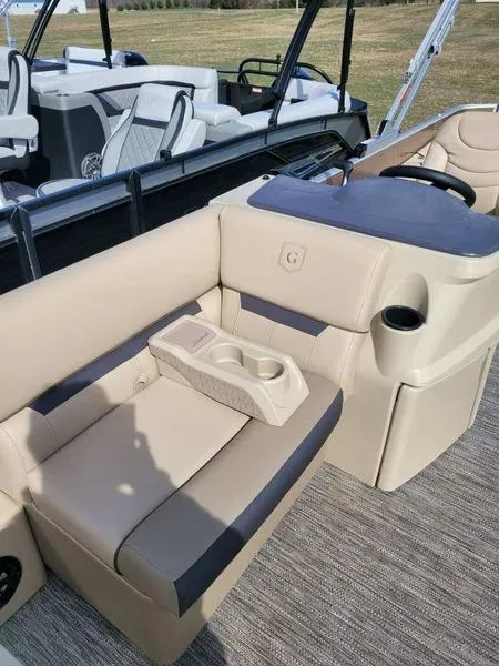 Slide: The Image of 2023 Godfrey Sweetwater SW2286F boat interior with beige seating and cup holders. - 5