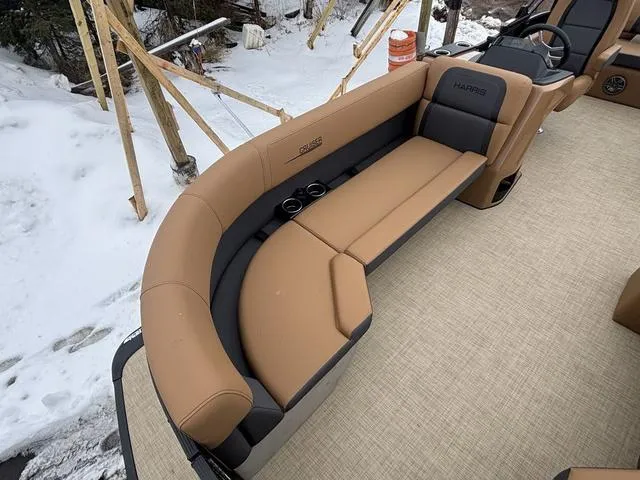 Slide: The Image of 2025 Harris CRUISER 230 SLDH boat interior with tan seating and cup holders. - 10