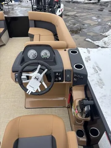 Slide: The Image of 2025 Harris CRUISER 230 SLDH boat interior with steering wheel and seating. - 14