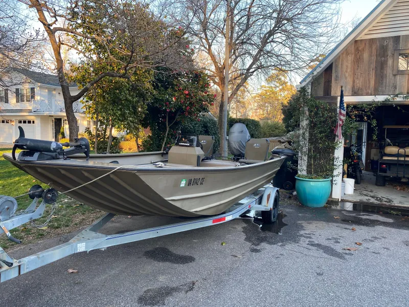 Slide: The Image of Boat on trailer in driveway, surrounded by trees and a house, G3 1966 CC model, 2007. - 0