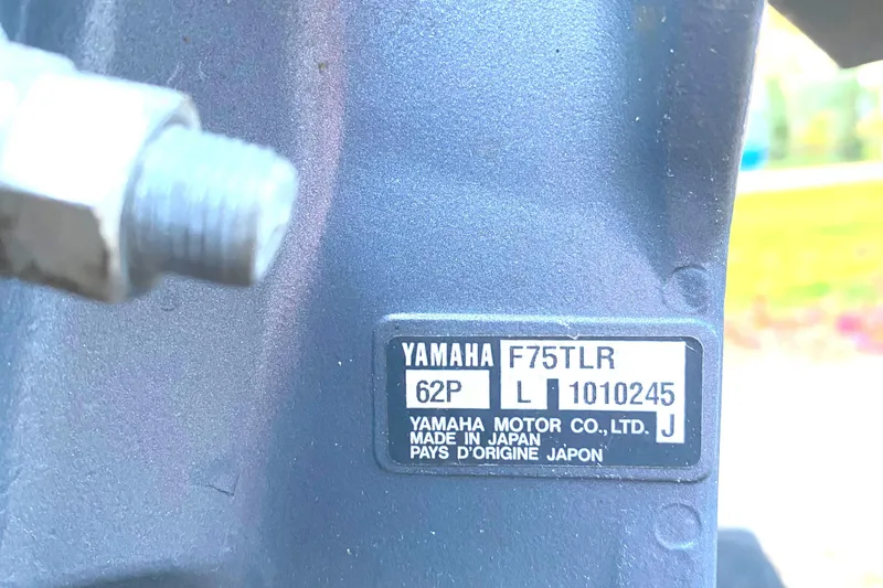 Slide: The Image of Close-up of Yamaha F75TLR engine label, showing model and manufacturing details. - 10