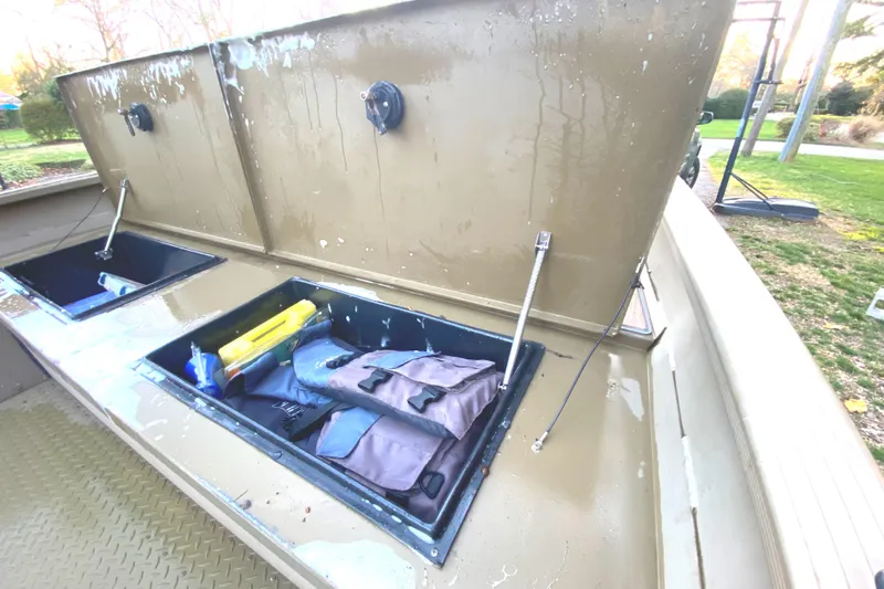Slide: The Image of Open storage compartments on a 2007 G3 1966 CC boat, containing gear and equipment. - 6