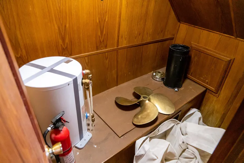 Slide: The Image of Storage area in 1985 Bluewater 46 Motor Yacht with propeller and fire extinguisher. - 20
