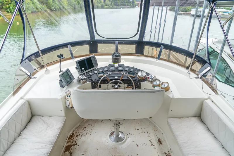 Slide: The Image of Helm of 1985 Bluewater 46 Motor Yacht with navigation instruments and river view. - 6