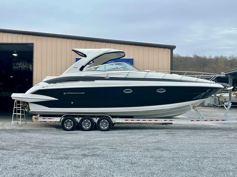 The Image of 2020 Crownline 350 SY boat on trailer outside a warehouse. - 0
