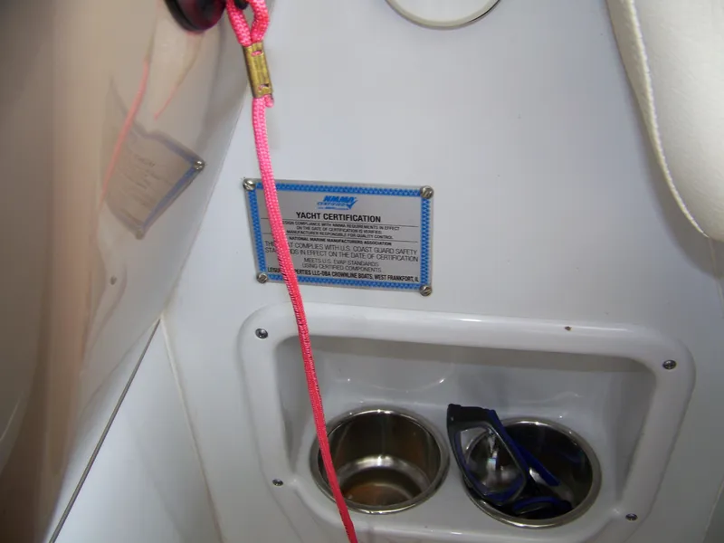 Slide: The Image of 2020 Crownline 350 SY yacht interior with certification plaque and cup holders. - 12