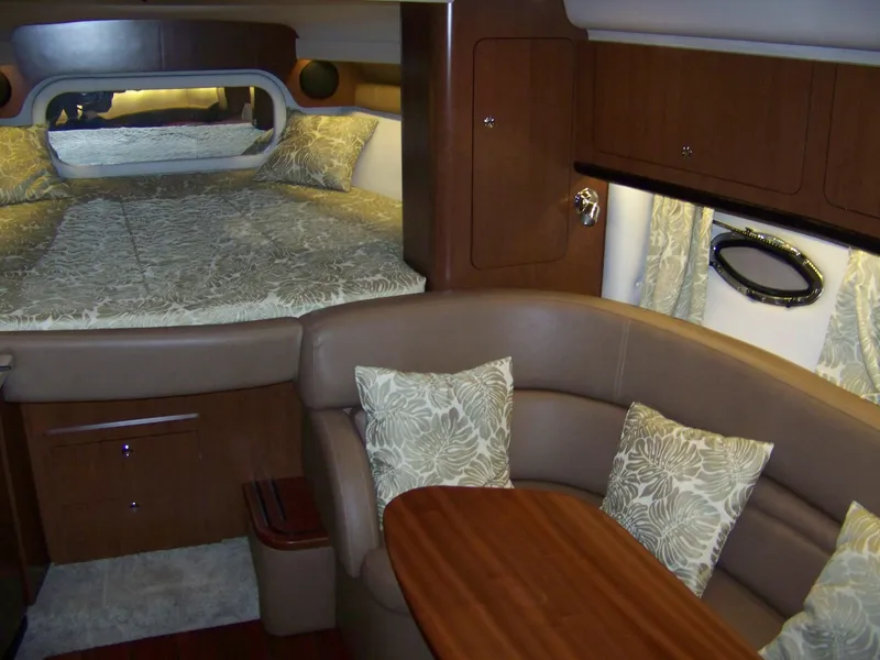 Slide: The Image of Interior of 2020 Crownline 350 SY yacht with cozy seating and elegant bedding. - 19