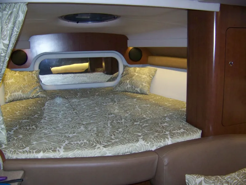 Slide: The Image of Luxurious cabin interior of 2020 Crownline 350 SY yacht with elegant bedding and wood accents. - 20