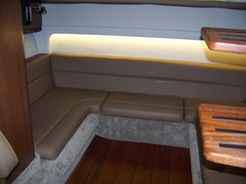 Slide: The Image of Interior of 2020 Crownline 350 SY yacht with beige seating and wooden accents. - 23