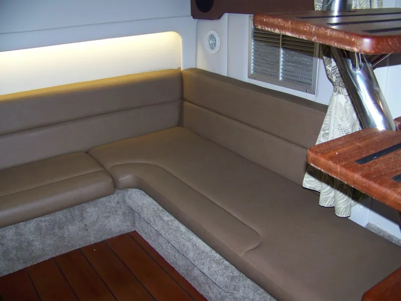 Slide: The Image of Interior of 2020 Crownline 350 SY yacht with brown seating and wooden accents. - 24