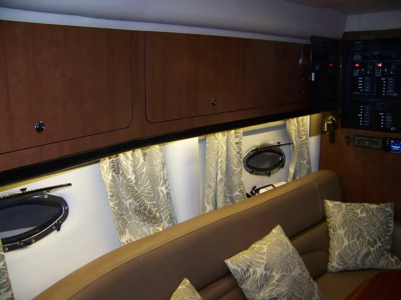 Slide: The Image of Interior of 2020 Crownline 350 SY yacht with elegant wood cabinets and plush seating. - 26