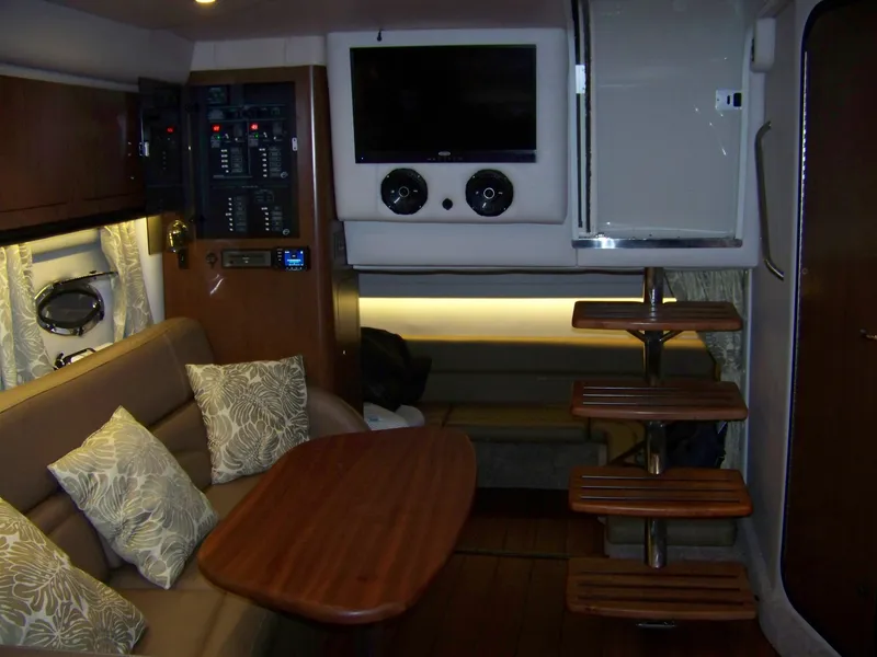 Slide: The Image of Interior of 2020 Crownline 350 SY yacht with seating, table, and entertainment system. - 27